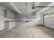 Spacious garage equipped with ample built-in cabinets and workbench, ideal for storage and projects at 12319 W Burgundy Ave, Littleton, CO 80127