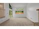 Sunny, open living room with large windows, sliding glass doors, and fireplace at 12319 W Burgundy Ave, Littleton, CO 80127