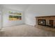 Comfortable living room with brick fireplace, high ceilings, and picture window at 12319 W Burgundy Ave, Littleton, CO 80127