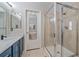 Bathroom showcasing a walk-in shower, modern vanity, and stylish mirror and lighting at 10523 Ashfield St # 5C, Highlands Ranch, CO 80126