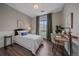 Cozy bedroom with hardwood floors, natural light, and a comfortable workspace at 10523 Ashfield St # 5C, Highlands Ranch, CO 80126