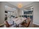 Dining room leading to kitchen and living room with an elegant chandelier and comfortable seating for four at 10523 Ashfield St # 5C, Highlands Ranch, CO 80126