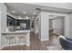 Open-concept kitchen with marble countertop, stylish barstools, and stainless steel appliances flowing into the living area at 10523 Ashfield St # 5C, Highlands Ranch, CO 80126
