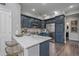 Stylish kitchen features navy cabinets, stainless appliances, and a modern marble countertop with barstool seating at 10523 Ashfield St # 5C, Highlands Ranch, CO 80126