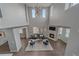 Lofted view of the living room with high ceilings, modern lighting, and a fireplace at 10523 Ashfield St # 5C, Highlands Ranch, CO 80126