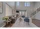 Inviting living room featuring a cozy fireplace, natural light, and a comfortable seating arrangement at 10523 Ashfield St # 5C, Highlands Ranch, CO 80126
