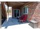 Covered patio of home features a small table with two chairs and ample shade at 24661 E Layton Pl, Aurora, CO 80016