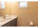 Powder bath featuring a modern vanity with white countertop, gray cabinets, and an elegant silver faucet at 24661 E Layton Pl, Aurora, CO 80016
