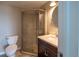 Well-lit bathroom with a glass-enclosed shower, vanity, and tiled floors at 24661 E Layton Pl, Aurora, CO 80016