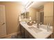 Dual sink bathroom with gray cabinetry, sleek countertops, and modern fixtures, offering a spacious and stylish design at 24661 E Layton Pl, Aurora, CO 80016