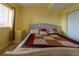 Comfortable bedroom with a plush bed, window and side table at 24661 E Layton Pl, Aurora, CO 80016