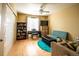 Cozy bedroom featuring a piano, bookshelves, and comfortable seating area at 24661 E Layton Pl, Aurora, CO 80016