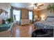 Bright bedroom with hardwood floors, dual windows, and stylish furniture at 24661 E Layton Pl, Aurora, CO 80016