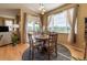 Bright dining area with hardwood floors, natural light, and access to the outdoor living space at 24661 E Layton Pl, Aurora, CO 80016
