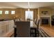Elegant dining room with hardwood floors, modern lighting, fireplace, and views into the adjacent living space at 24661 E Layton Pl, Aurora, CO 80016