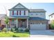 Charming two-story home with a well-manicured lawn and a two-car garage in a peaceful neighborhood at 24661 E Layton Pl, Aurora, CO 80016