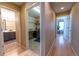 Hallway connecting bathroom, laundry room and bedroom with hardwood floors and access to all rooms at 24661 E Layton Pl, Aurora, CO 80016