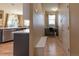 Hallway with access to kitchen, office nook, and front door with hardwood floors and neutral wall paint at 24661 E Layton Pl, Aurora, CO 80016