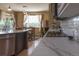 Bright eat-in kitchen with a large island, stainless appliances, and natural light coming through the patio door at 24661 E Layton Pl, Aurora, CO 80016