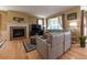 Bright living room featuring a fireplace, hardwood floors, comfortable seating, and plenty of natural light at 24661 E Layton Pl, Aurora, CO 80016