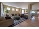 Inviting living room with hardwood floors, recessed lighting, and comfortable seating with a view of the dining room at 24661 E Layton Pl, Aurora, CO 80016