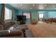Expansive living room with blue walls, comfortable seating, and dining area at 24661 E Layton Pl, Aurora, CO 80016