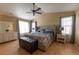 Spacious primary bedroom with a king-sized bed, dresser, and plenty of natural light at 24661 E Layton Pl, Aurora, CO 80016