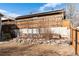 Landscaped backyard with stone retaining wall and wooden fence at 316 Perry St, Denver, CO 80219