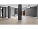 Finished basement with grey walls, laminate floors and sliding glass door at 316 Perry St, Denver, CO 80219
