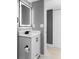 Modern bathroom with white vanity, black fixtures, and illuminated mirror at 316 Perry St, Denver, CO 80219