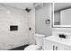 Modern bathroom with marble tile, black accents, and updated fixtures at 316 Perry St, Denver, CO 80219