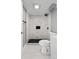 Clean bathroom with marble tile shower and black hexagon floor at 316 Perry St, Denver, CO 80219