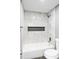 Bathroom featuring a clean white bathtub and marble-style tile at 316 Perry St, Denver, CO 80219
