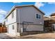 Two-story house with gray siding, and a small backyard at 316 Perry St, Denver, CO 80219