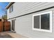 Gray siding house with sliding glass door and window at 316 Perry St, Denver, CO 80219