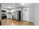 Updated kitchen with stainless steel appliances and white cabinets at 316 Perry St, Denver, CO 80219