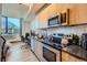 Modern kitchen with stainless steel appliances and wood cabinets at 603 Inca St # 213, Denver, CO 80204