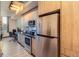 Modern kitchen with stainless steel appliances and wood cabinets at 603 Inca St # 213, Denver, CO 80204