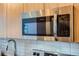 Stainless steel microwave built into modern cabinetry at 603 Inca St # 213, Denver, CO 80204