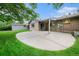 Backyard featuring a patio, shed, lush greenery and a brick house at 6427 S Ingalls St, Littleton, CO 80123