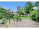 Lush backyard featuring a large lawn, mature trees, garden beds and a storage shed at 6427 S Ingalls St, Littleton, CO 80123