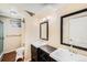 Updated bathroom featuring double sinks and custom cabinets at 6427 S Ingalls St, Littleton, CO 80123