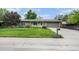 Charming ranch home features a manicured lawn, lovely landscaping, and a two-car garage at 6427 S Ingalls St, Littleton, CO 80123