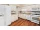 Cozy kitchen with white appliances, granite countertops, and ample cabinet space at 6427 S Ingalls St, Littleton, CO 80123