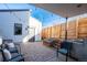 Backyard patio featuring pavers, landscaping, outdoor seating, string lights, and access to the house at 3600 N Pecos St, Denver, CO 80211