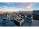 Rooftop deck offering skyline views, complete with modern firepit and comfortable lounge seating at 3600 N Pecos St, Denver, CO 80211
