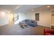 Finished basement living area boasts a cozy sectional sofa and a contemporary staircase at 3600 N Pecos St, Denver, CO 80211