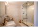 Modern bathroom showcasing double sink vanity, marble countertops and a glass-enclosed walk-in shower at 3600 N Pecos St, Denver, CO 80211