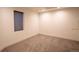Minimalist bedroom with neutral walls and carpet, featuring a window with blinds at 3600 N Pecos St, Denver, CO 80211