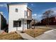 Striking modern home with contrasting white stucco and wood siding on a sunny day at 3600 N Pecos St, Denver, CO 80211